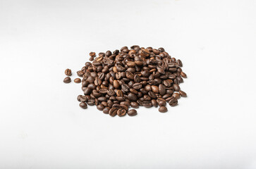 Fresh roasted coffee beans on a white background.