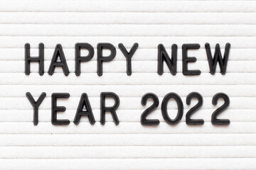 Black color letter in word happy new year 2022 on white felt board background