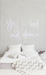 Light loft bedroom with neon sign