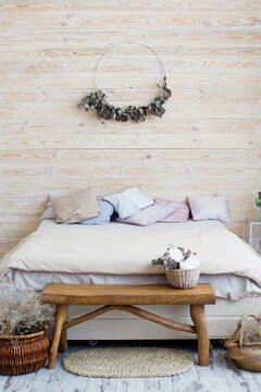 Light Bohemian Bedroom With Wooden Wall