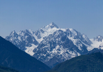Fototapeta na wymiar View of the Nursultan mountain peak in the snow between the gorge