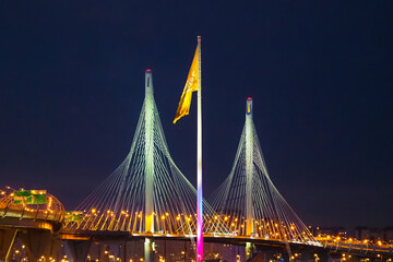 Western high-speed diameter in night, intracity toll highway in Saint Petersburg, Russia. 105 meter flagpole yacht club  on Krestovsky istland