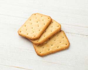 Cracker cookies on white wooden table background.