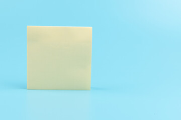 yellow sticky notes on blue background. Square sticky paper reminders with shadows
