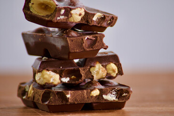 dark chocolate with hazelnuts on a wooden table