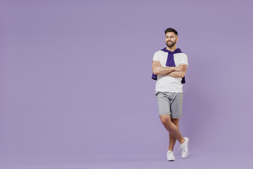 Fototapeta na wymiar Full size body length happy young brunet man 20s wear white t-shirt purple shirt hold hands crossed look aside isolated on pastel violet background studio portrait. People emotions lifestyle concept.