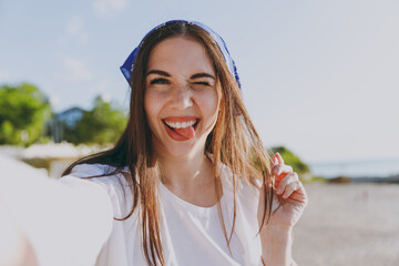 Close up cute young traveler tourist woman 20s in blue bandana shirt summer casual clothes rest do...