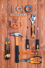 Set of construction tools on a brown wooden background. Hammer, wrench, pliers and screwdriver. Greeting card for the holiday Labor Day, Father's Day. Equipment, workplace. DIY concept. Flat lay.