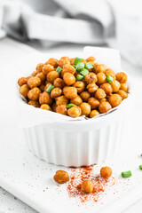 Baked smoked paprika spicy chickpea in a bowl. Space for text.