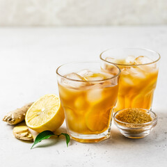 Summer mocktail, iced lemon ginger tea in glasses. Space for text.