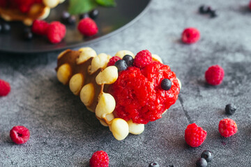 Delicious hong kong waffles. Waffles with strawberry ice cream and berries. Waffles on the table 