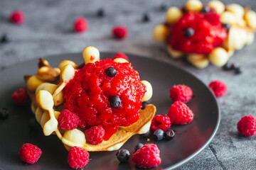 Delicious hong kong waffles. Waffles with strawberry ice cream and berries. Waffles on the table 