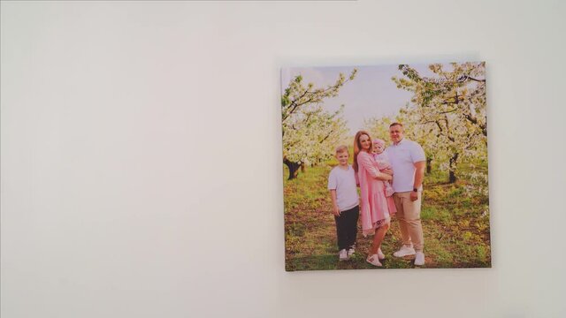 white background leaf through photobook from family photo shoot in spring garden