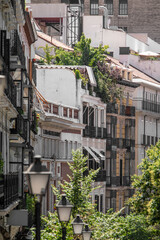 Fototapeta na wymiar Old facades with balconies and wrought iron gazebos on a street in the center of Madrid
