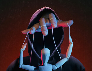 The concept of extortion, blackmail. Man in a hoodie and a puppet. - obrazy, fototapety, plakaty