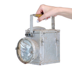 Old metal railroad lantern in hand on white background isolation