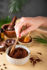  The process of making a homemade coffee scrub for skin care. Eco-friendly cosmetics, vertical photo