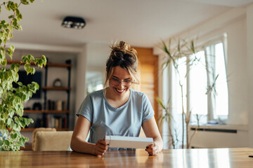 Adult woman, preparing a present for her friend.