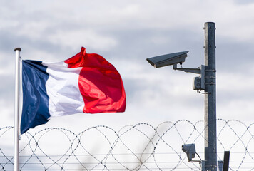 French border, embassy, surveillance camera, barbed wire and Flag of France, concept picture..