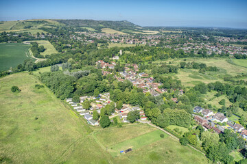 Fototapeta na wymiar Bramber village and the village centre and Bramber Castle behind St Nicholas Church in the countryside of West Sussex, aerial photo.
