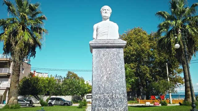 Statue of Aristotle made of white stone in ancient greek style on a street of a town, Greece