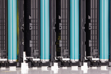Four used laser printer toner cartridges isolated white background.