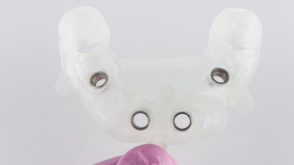 classic surgical template for implantation of four implants for the upper jaw on a white background