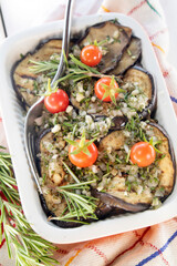 Tray with grilled aubergines and flavored Pachino tomatoes