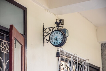 An outdoor or wall clock in the area of a terrace