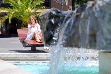 laughing happy woman relaxing barefoot in the sunshine