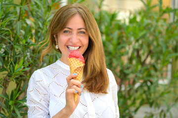 Stylish woman holding a berry ice cream cone