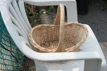 basket on a white plastic lawn chair