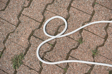 white braided cord on inter locking brick pavement