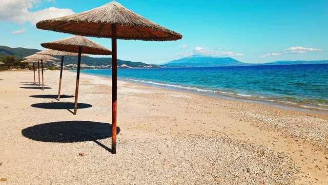Beach umbrellas on the Aegean sea coast in Asprovalta, Greece