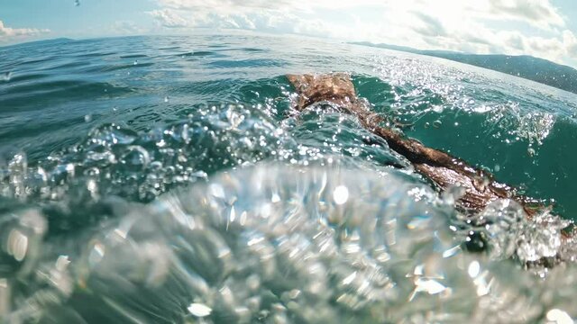 Man swimming in the Aegean sea. Slow motion, underwater shooting. Greece