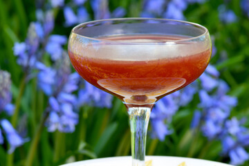 Tepache and Cachaça based cocktail on purple hyacinth background