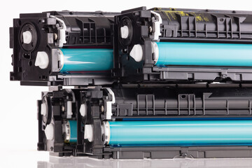 Four used laser printer toner cartridges isolated white background.
