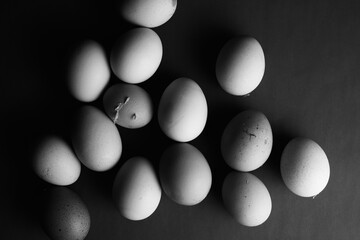 Flat lay of natural organic chicken eggs in black and white.