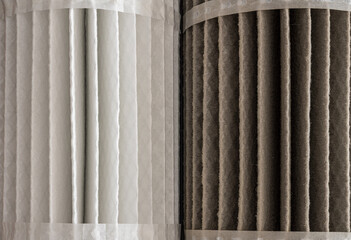 Close view of two HVAC air filters to show the difference between a clean and dirty one ready for...