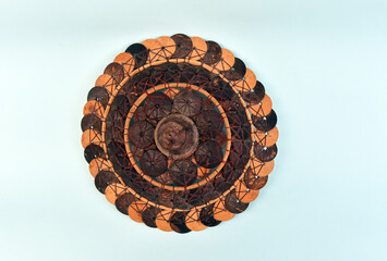 Basket Cover,hand made from coconut shell in brown color isolated on color background,concept of hand made product and earth friendly