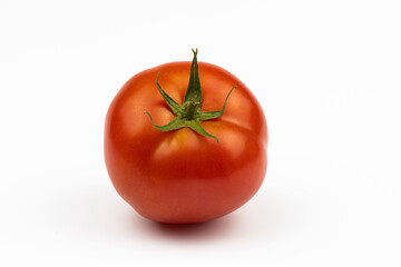Fresh tomato, close-up isolated on a white background.