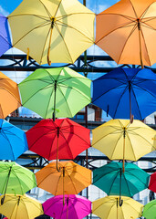 Fototapeta na wymiar Colorful umbrellas. Colorful umbrellas in the sky. Street decoration from umbrellas. Background of umbrellas. 