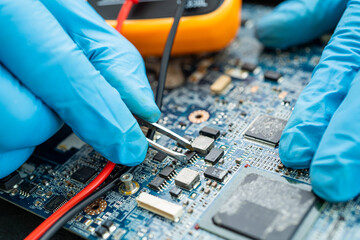 technician repairing inside of hard disk by soldering iron. Integrated Circuit. the concept of...