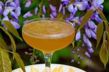 Irish Whisky cocktail with wisteria background