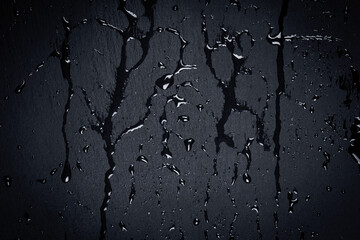 Water on dark stone surface