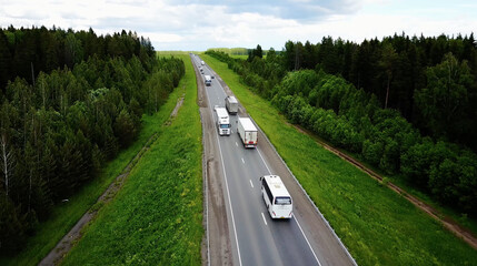 Beautiful landscape with a ride on the highway the trucks and a few cars at sunset. aerial view