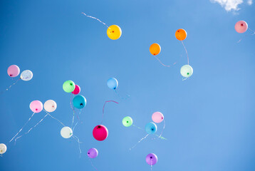 balls of different colors on blue sky