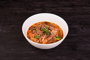 soup with beef pieces, bean sprouts and greens