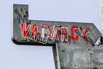 Vacancy sign on a deserted motel - worn, broken and forgotten VACANCY sign.