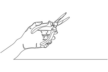 Continuous one line of hand holding pliers  in silhouette on a white background. Linear stylized.Minimalist.
